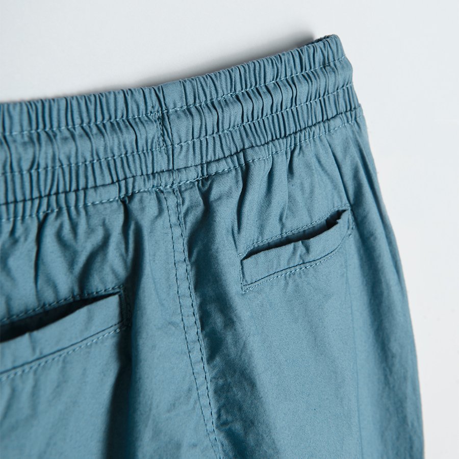 Trousers with cord and elastic band around the ankles