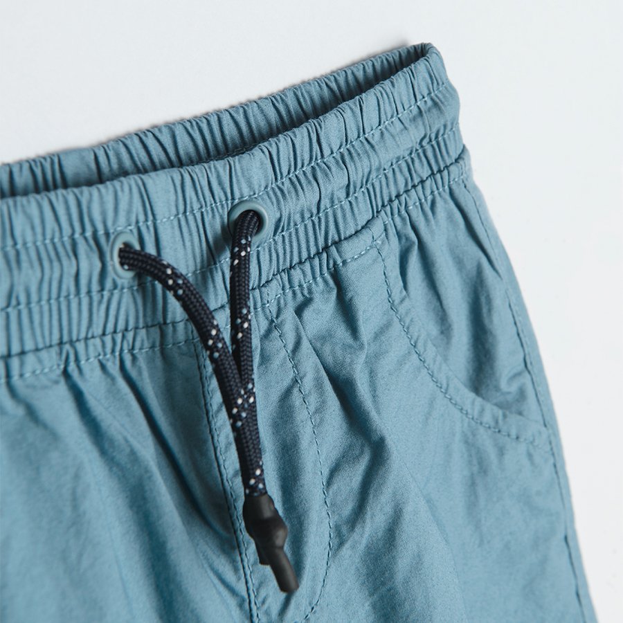 Trousers with cord and elastic band around the ankles