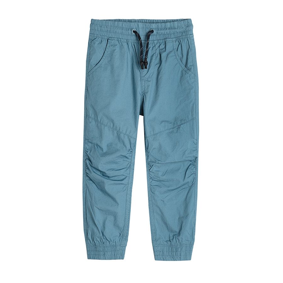 Light blue trousers with elastic waist and elastic band around the ankles
