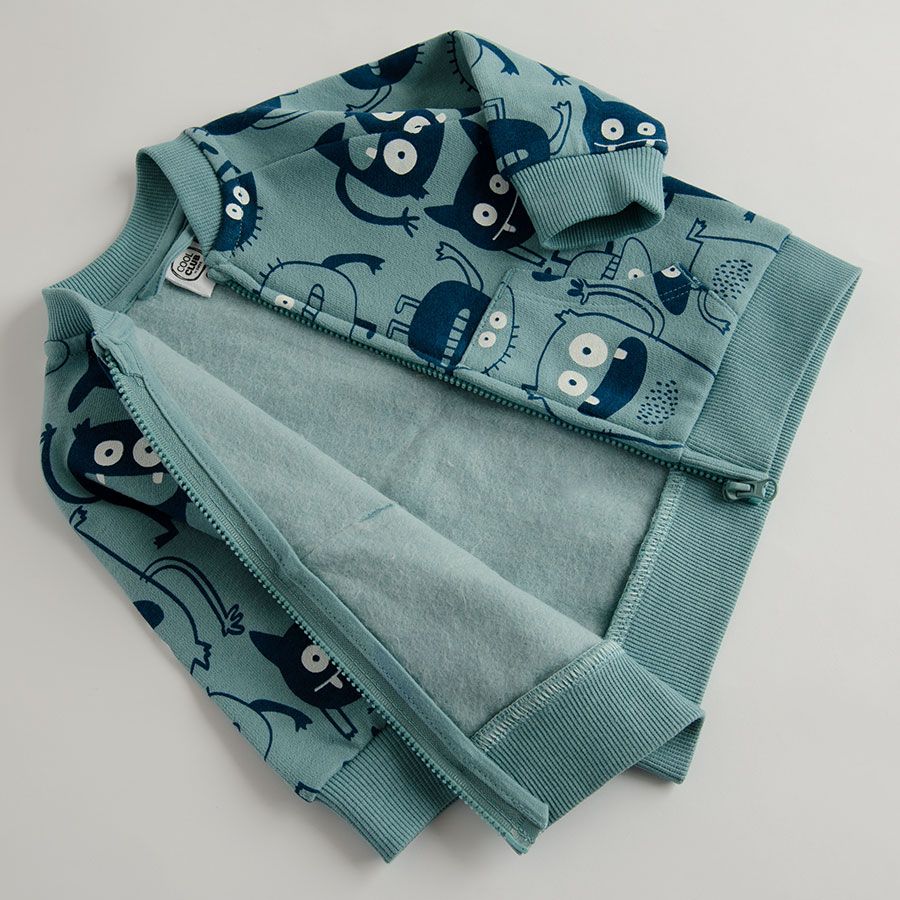 Light blue zip through sweatshirt with monsters print