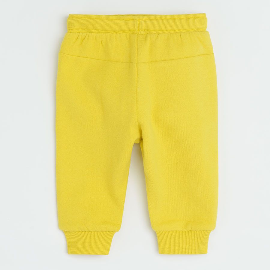 Yellow jogging pants with funny face on knee
