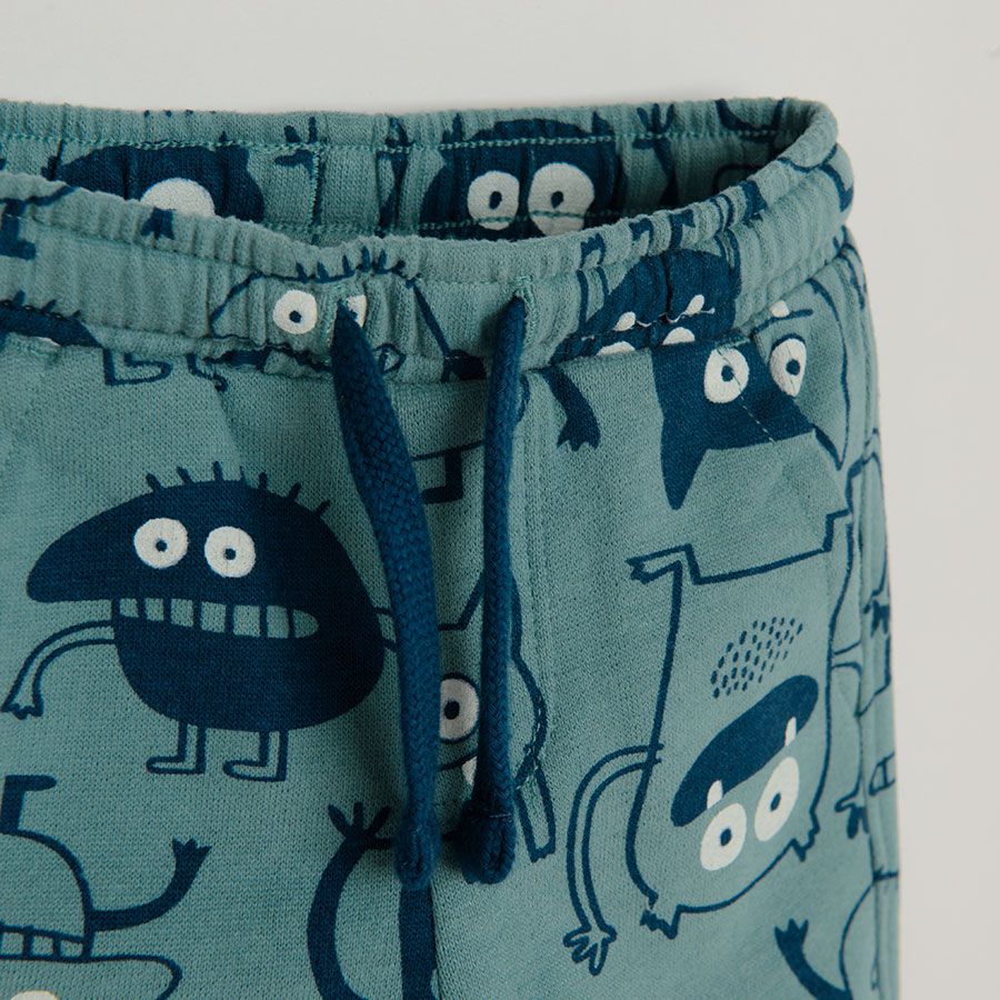 Light blue jogging pants with monsters print