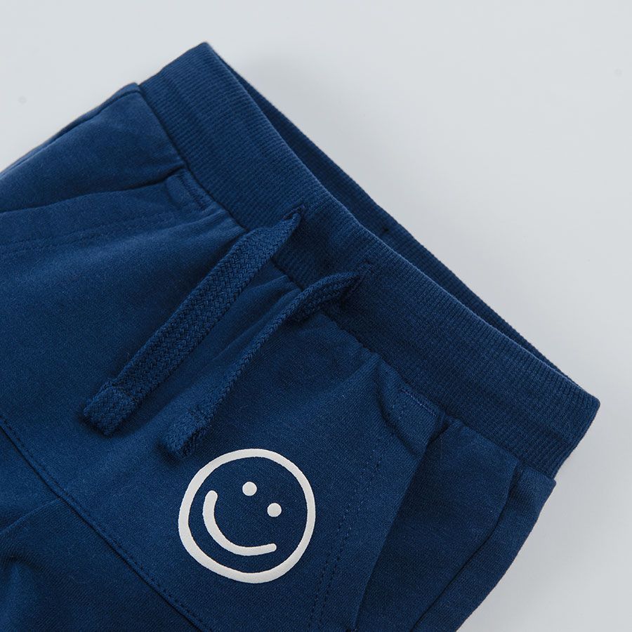 Navy blue jogging pants with pockets on the front and adjustable waist