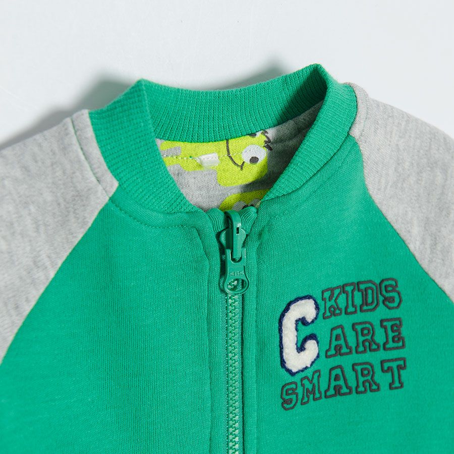 Green zip through hooded sweatshirt with animals print on the inside lining