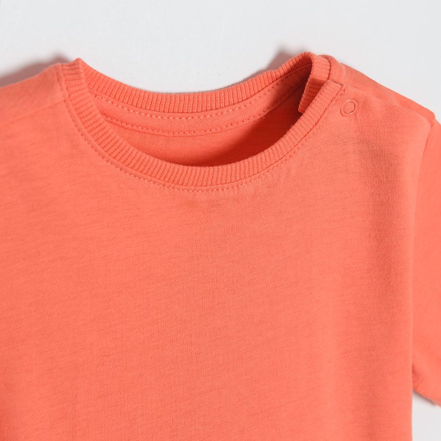 Orange short sleeve T-shirt with poppers on the shoulder