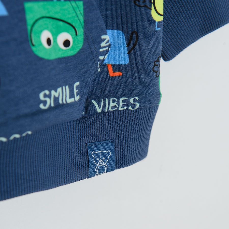Navy blue sweatshirt with happy smiley creatures