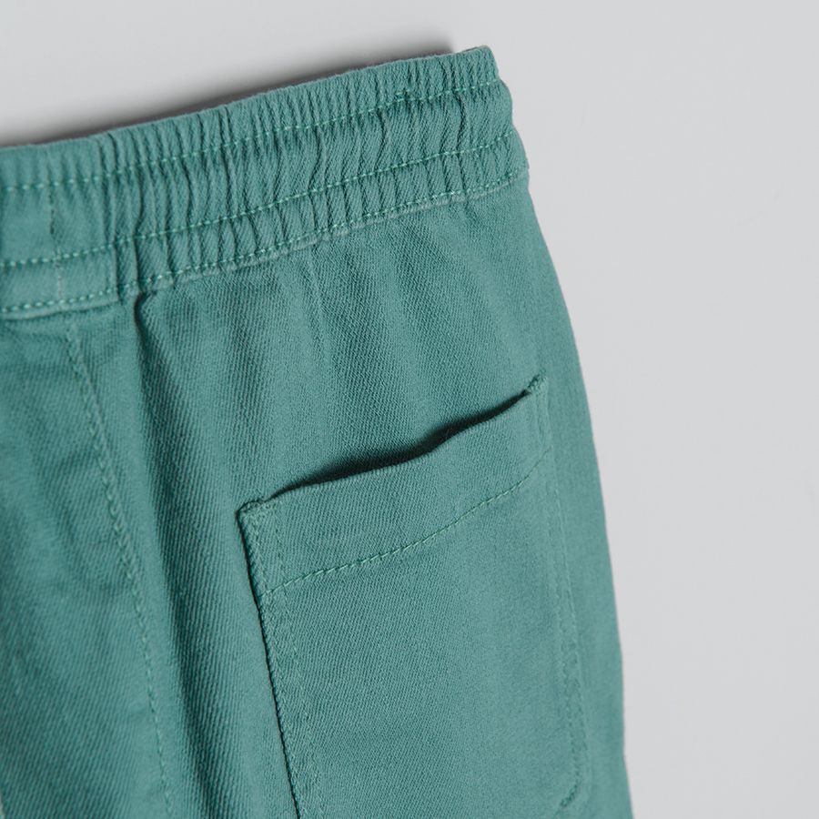 Blue trousers with adjustable waist and side pockets