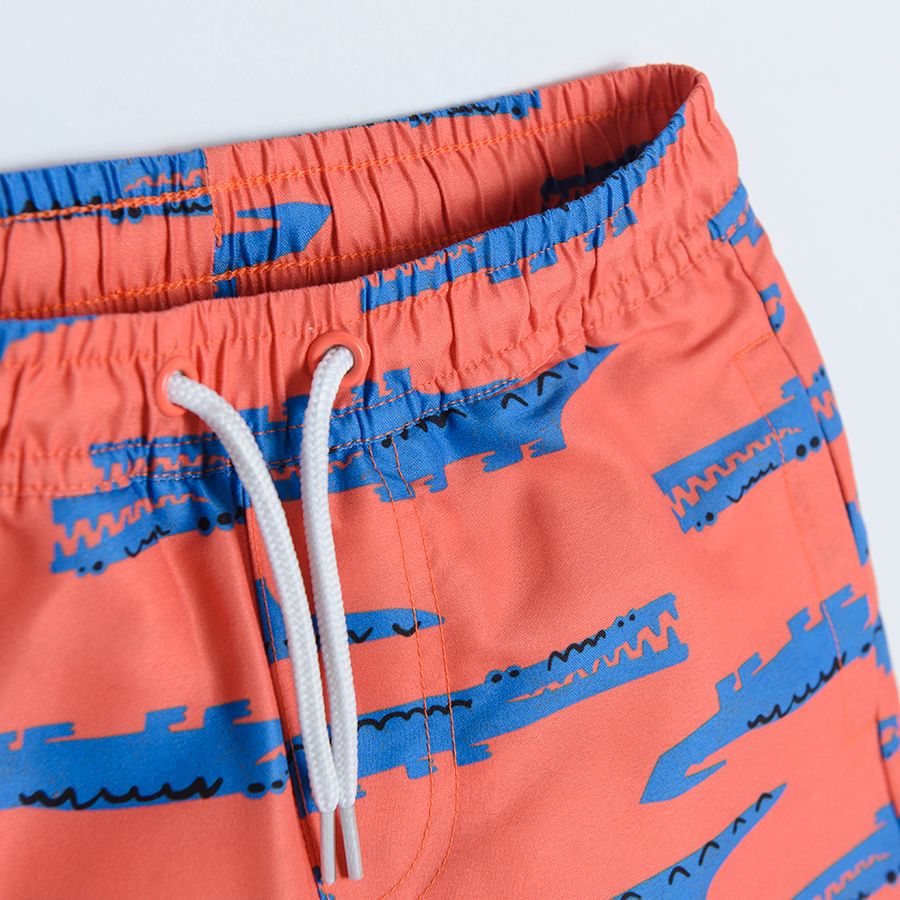 Red swimming shorts with crocodiles print