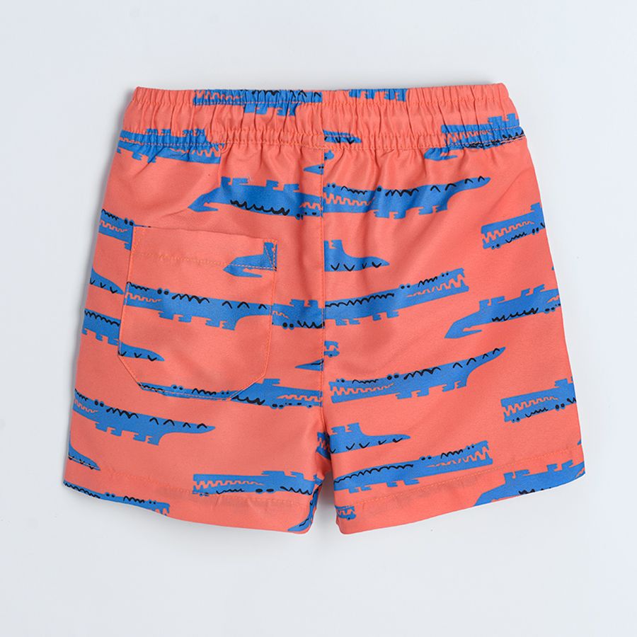 Red swimming shorts with crocodiles print
