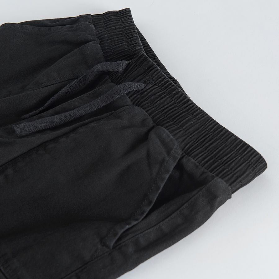 Black trousers with external side pockets and adjustable waist