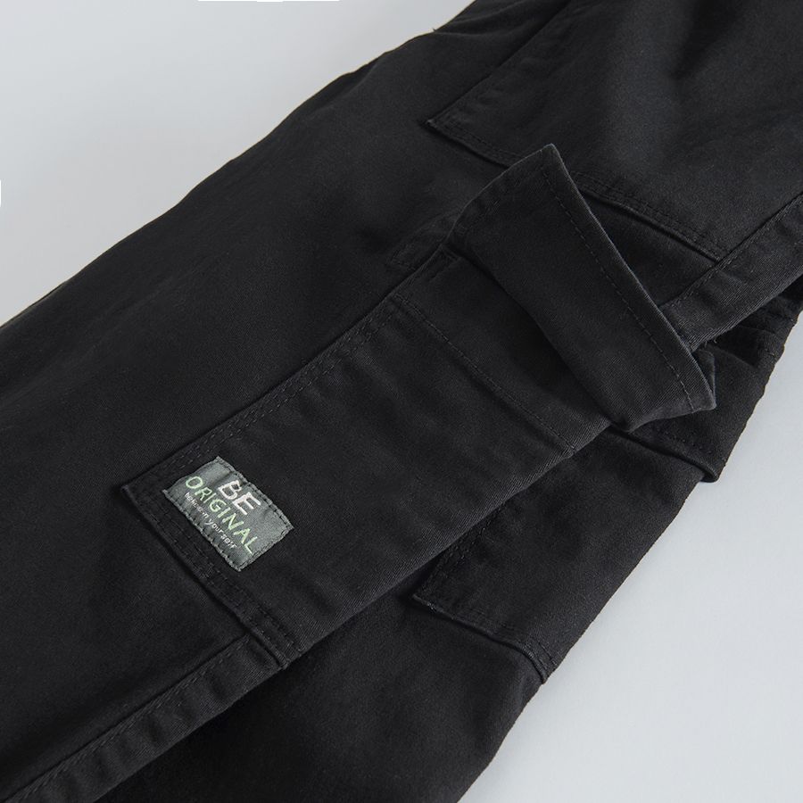 Black trousers with external side pockets and adjustable waist
