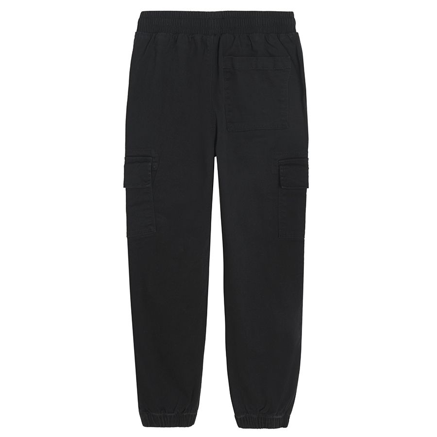 Black trousers with external side pockets and adjustable waist