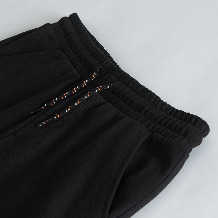 Black jogging pants with print on one knee