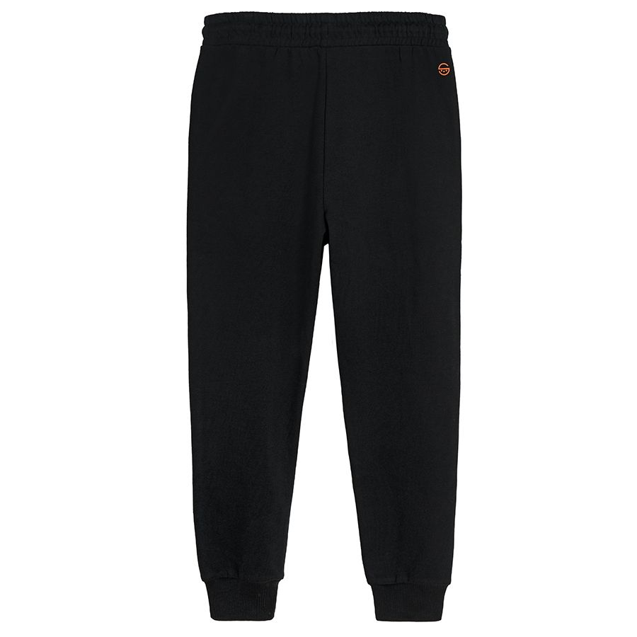 Black jogging pants with print on one knee