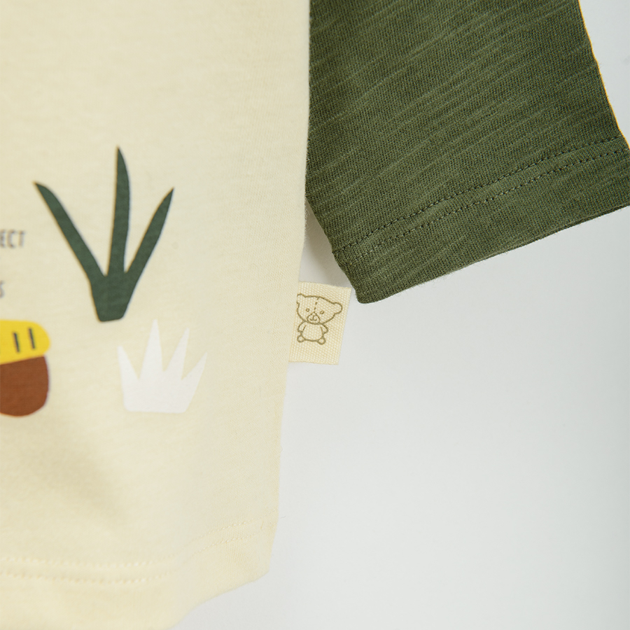 Beige long sleeve blouse with green sleeves and bear print