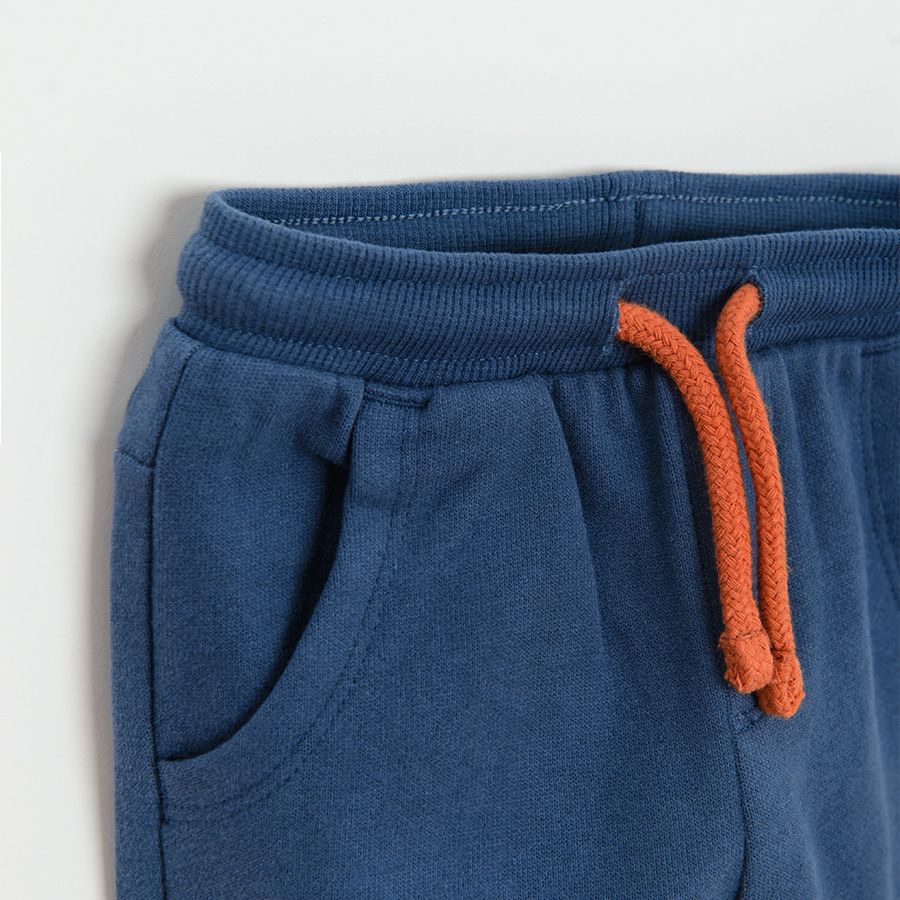 Blue jogging pants with trucks print on the knees