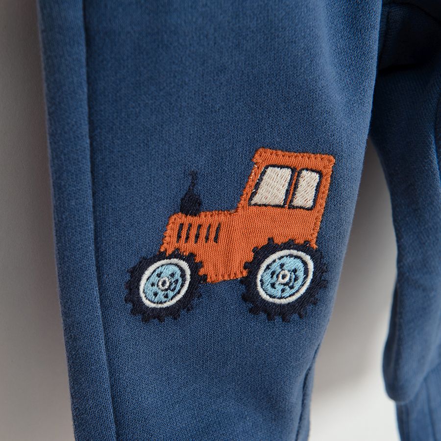 Blue jogging pants with trucks print on the knees