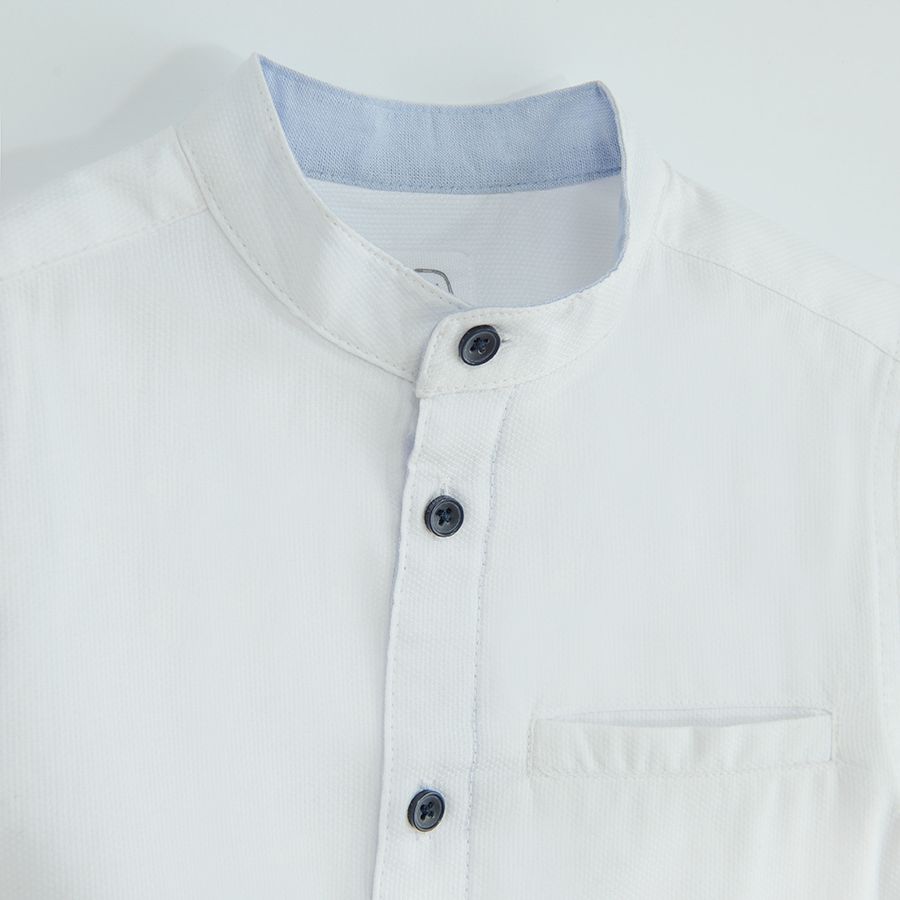 White long sleeve shirt with sleeve rolling up to a button