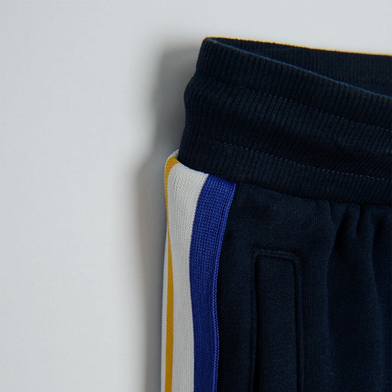 Black jogging pants with light blue, red and white stripe on the side