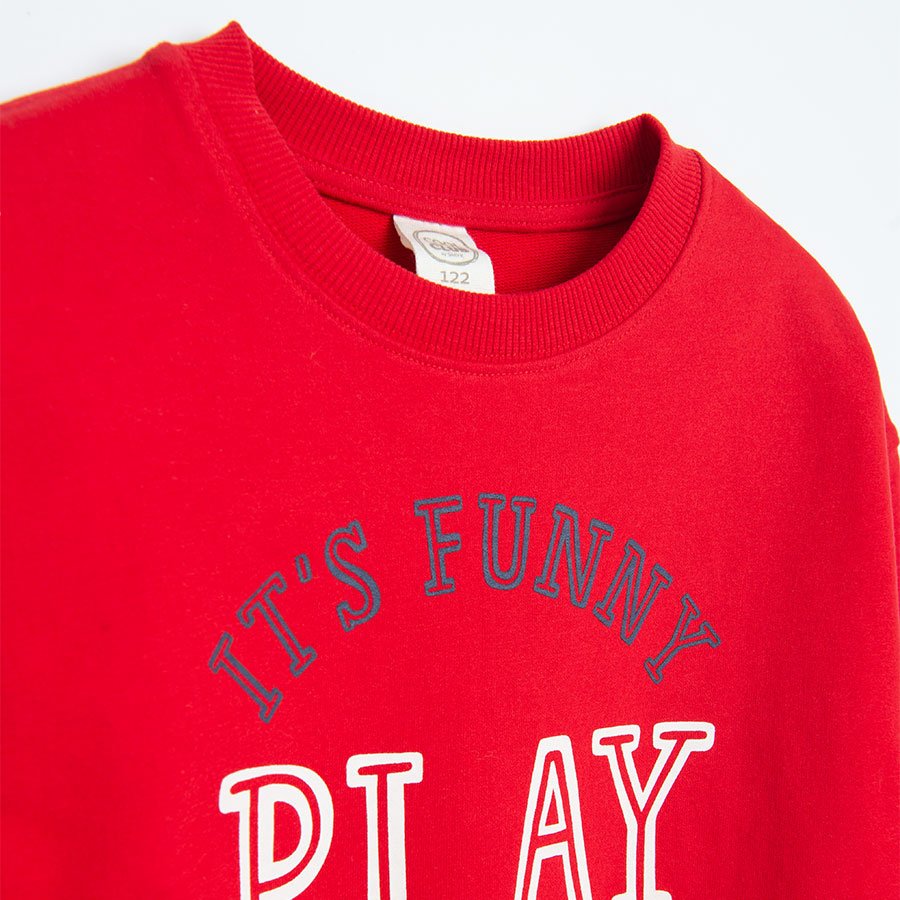 Red sweatshirt with 'It’s Funny Paly' print