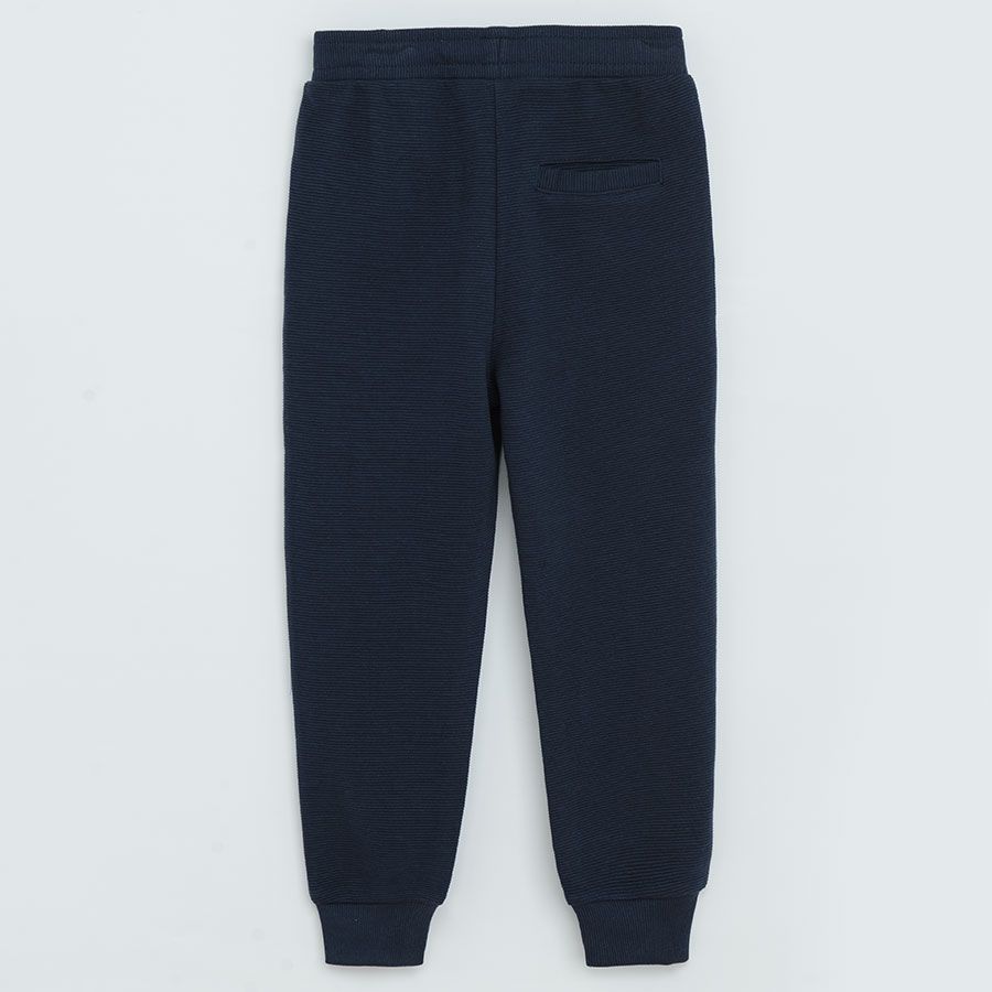 Dark blue jogging pants with cord and elastic around the ankles