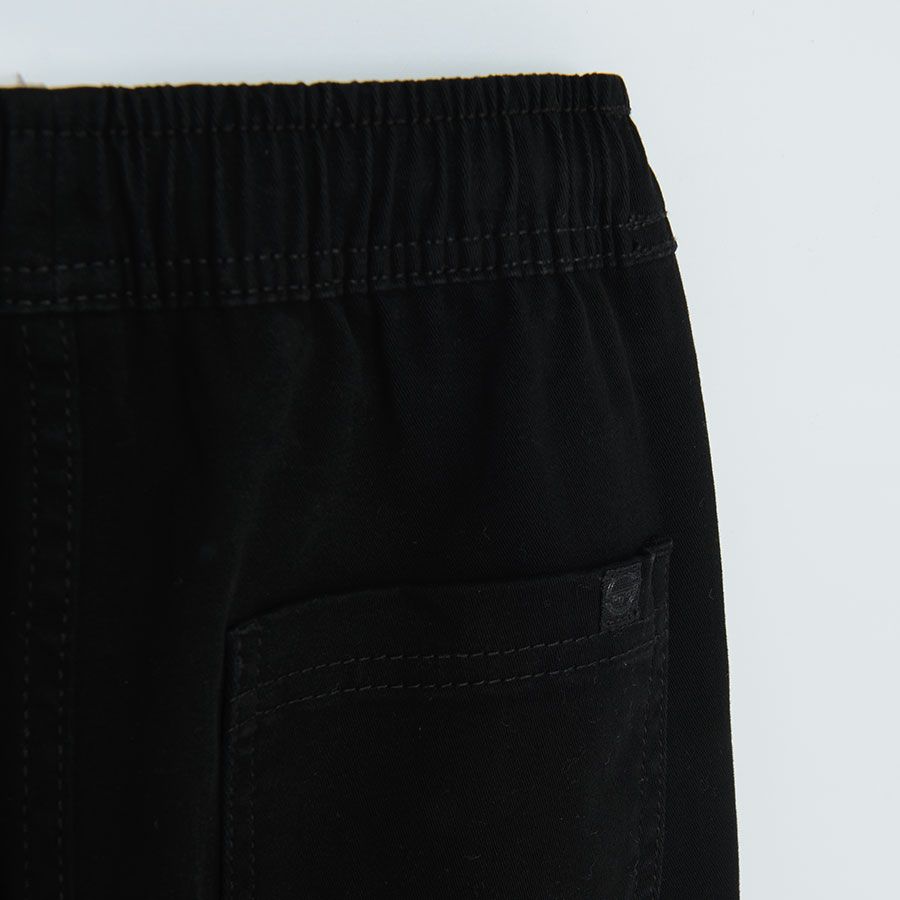 Black trousers with elastic cord on the waist