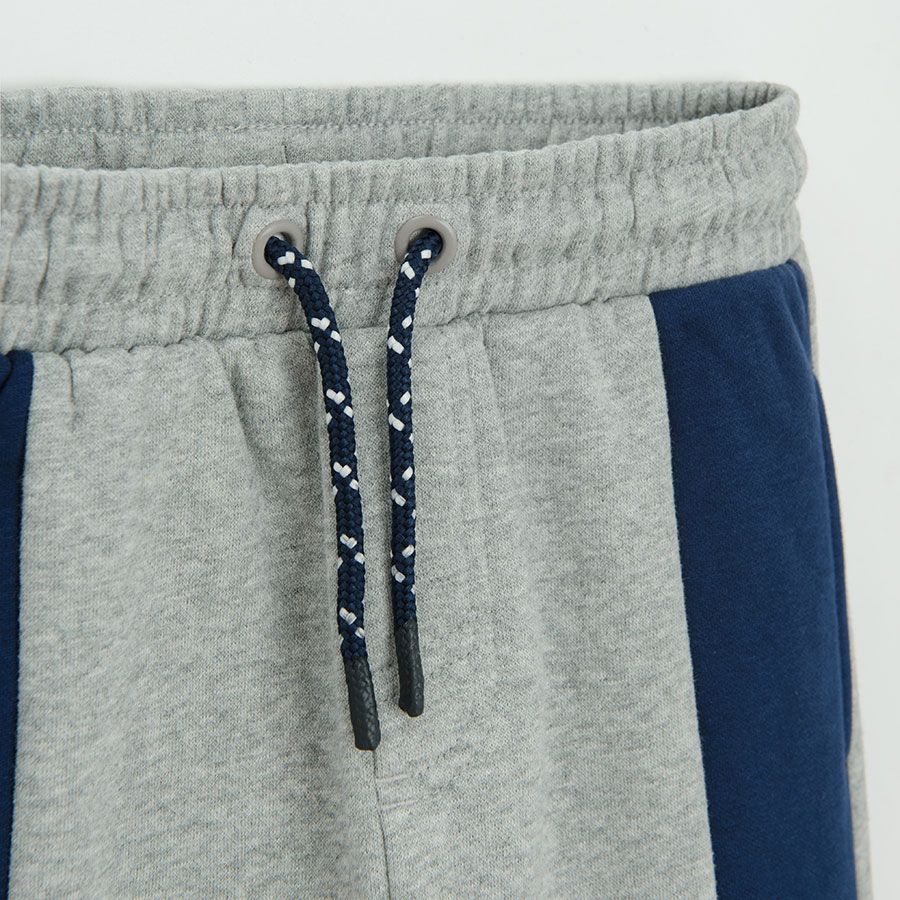 Grey jogging pants with blue and green stripes