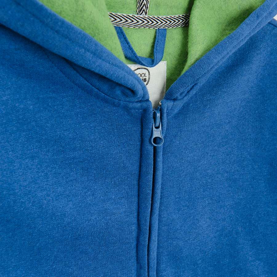 Blue zip through sweatshirt with fluo green lining on the hood