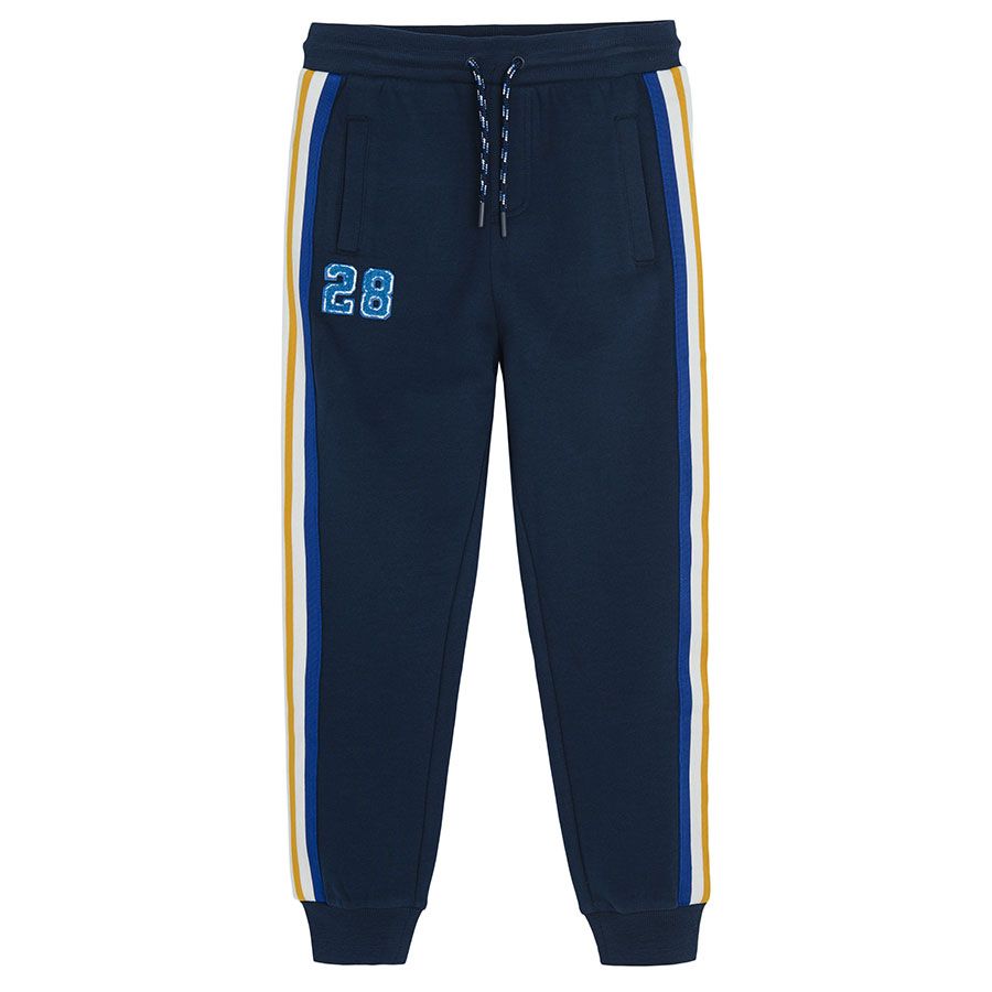 Dark blue jogging pants with yellow, white and blue stripe on the side