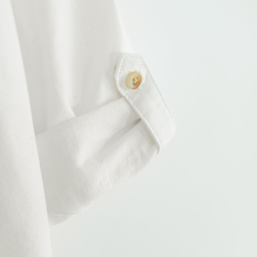 White long sleeve shirt with sleeve rolling up to a button