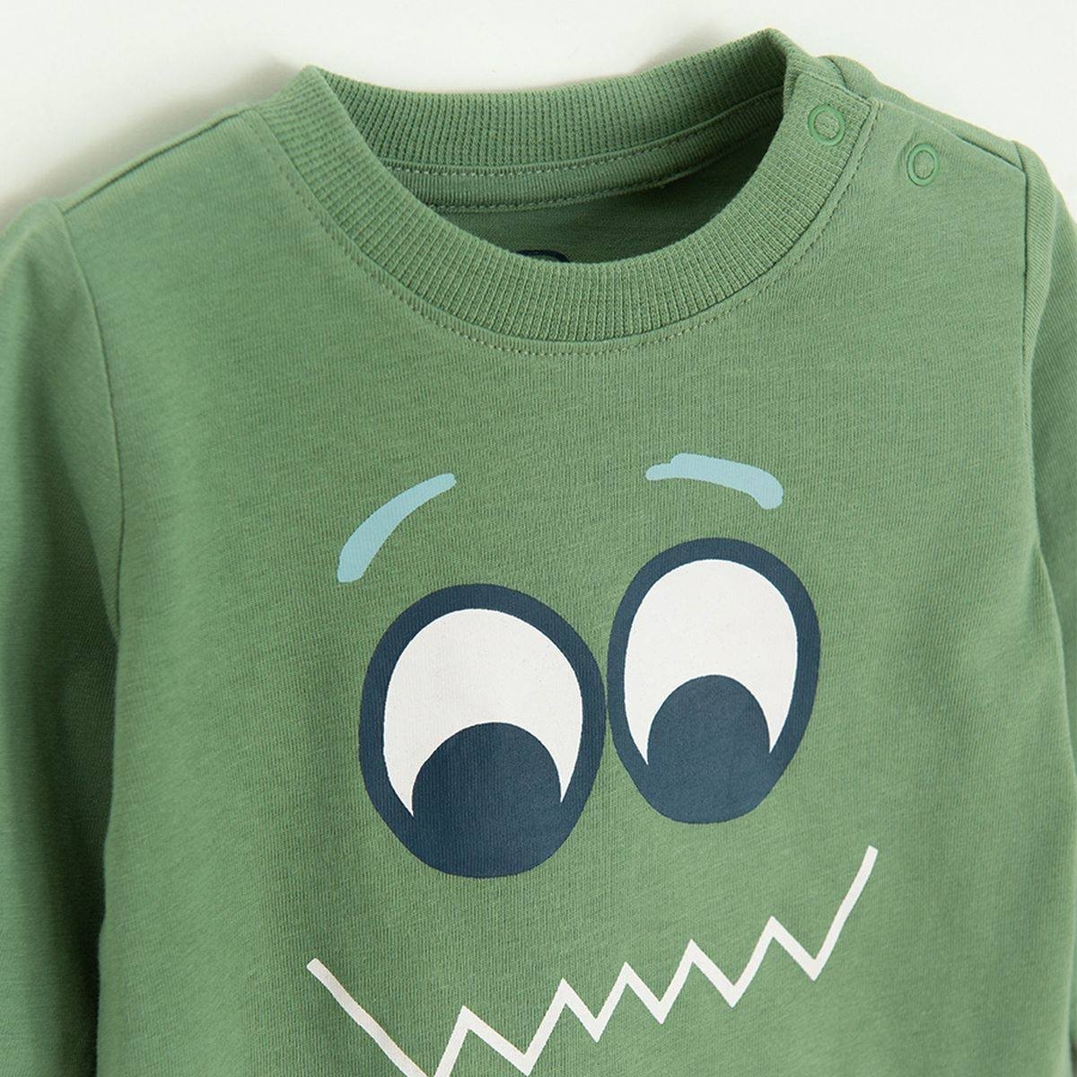 Green long sleeve blouse with funny face print