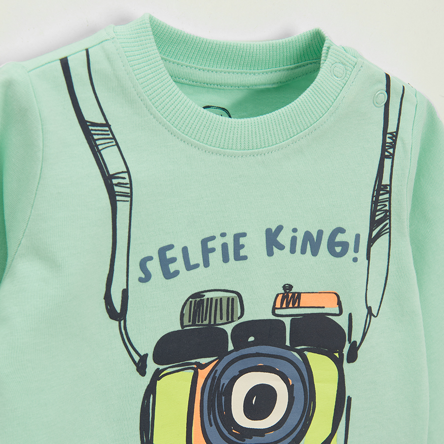 Light blue long sleeve blouse with camera and SELFIE KING print