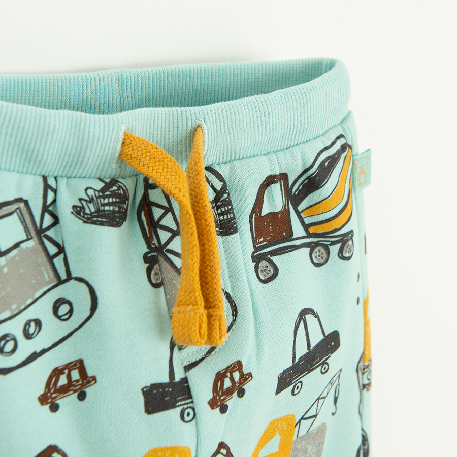 Light blue sweatpants with cord and various trucks print