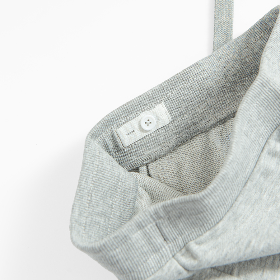 Grey jogging pants with corded waist and elastic around the ankles
