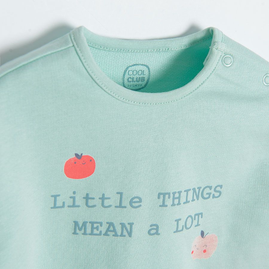 Light blue long sleeve blouse with "Little things mean a lot" print