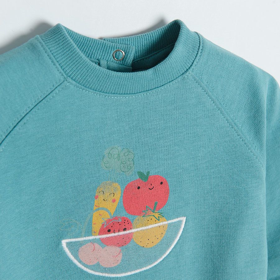 Blue long sleeve overhead sweatshirt with bowl of fruit print