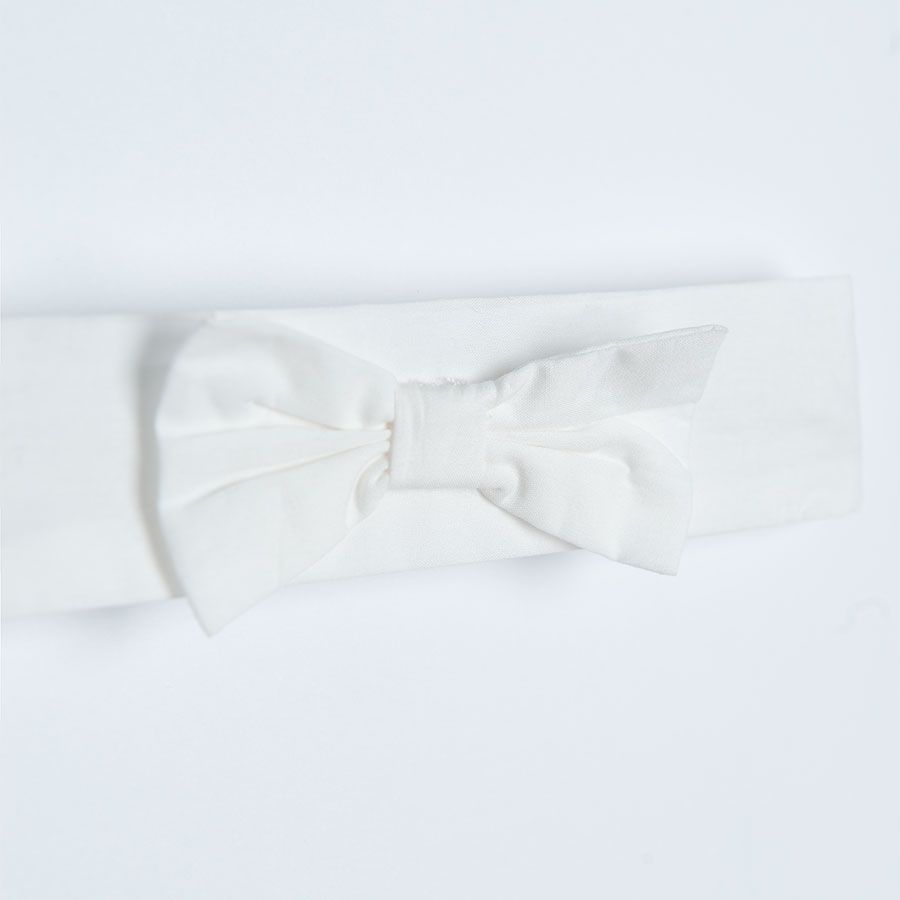 White sleeveless dress/bodysuit with flowers on the skirt and matching headband