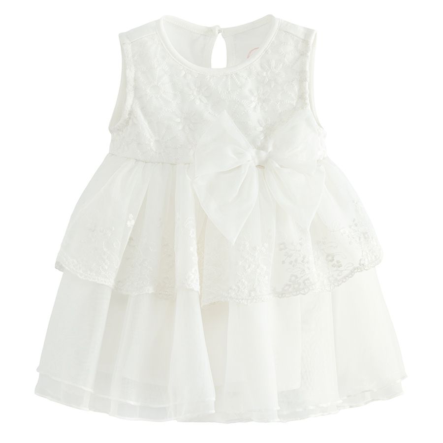 White sleeveless party dress with a bow