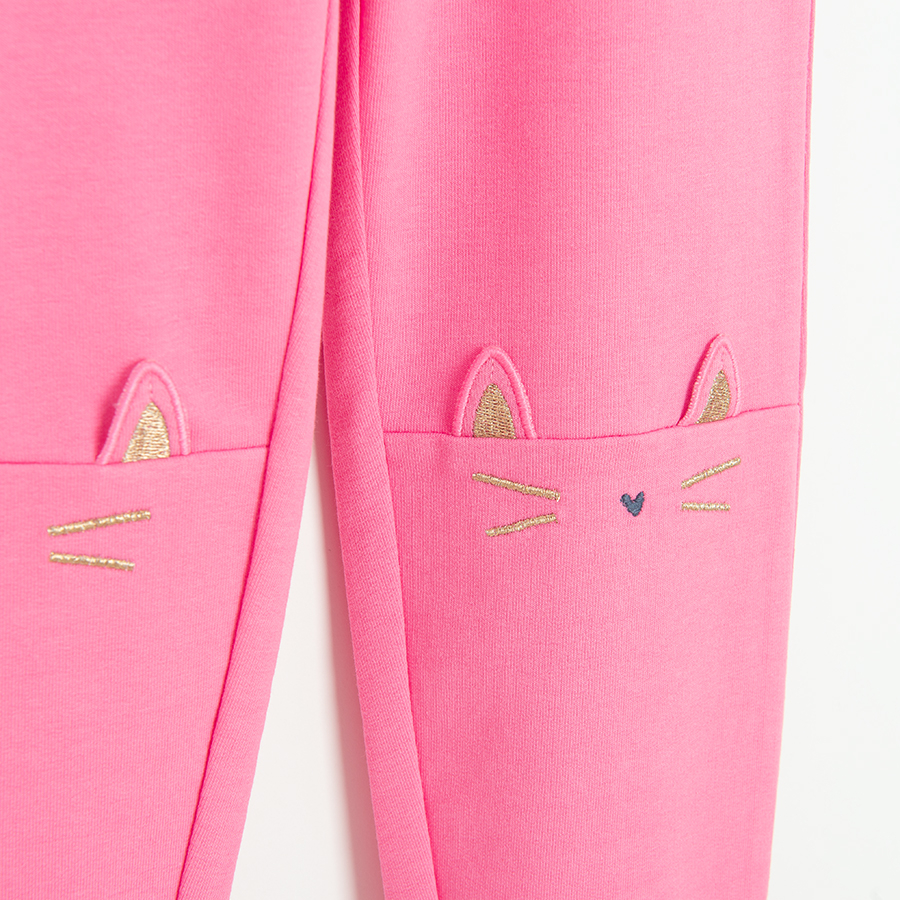 Pink leggings with kitten face print on the knees