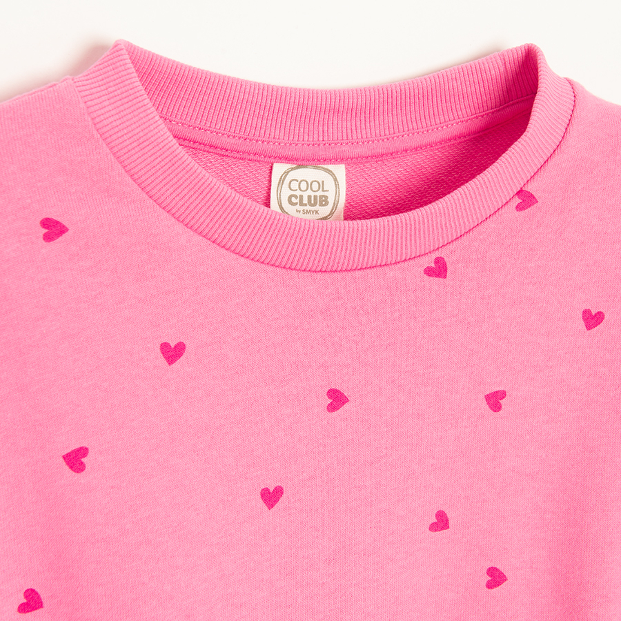Pink sweatshirt with red hearts print