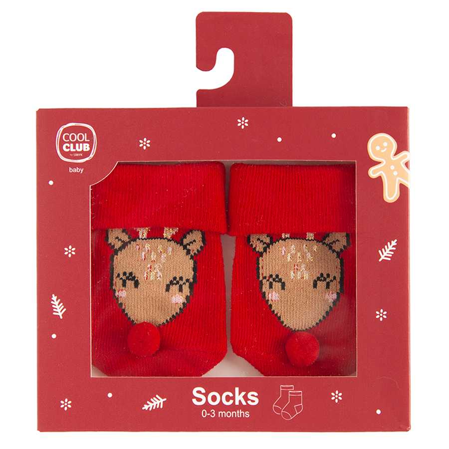 Red socks in box with Santa Claus pattern