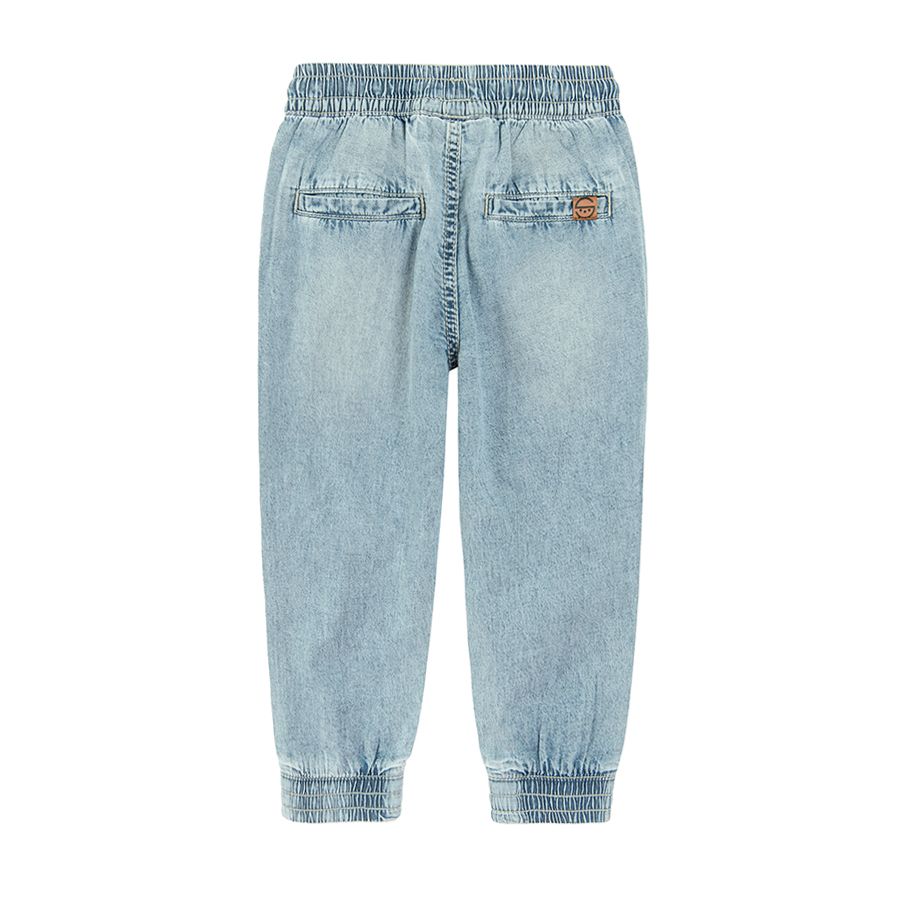 Denim trousers with cord and elastic band around the ankles