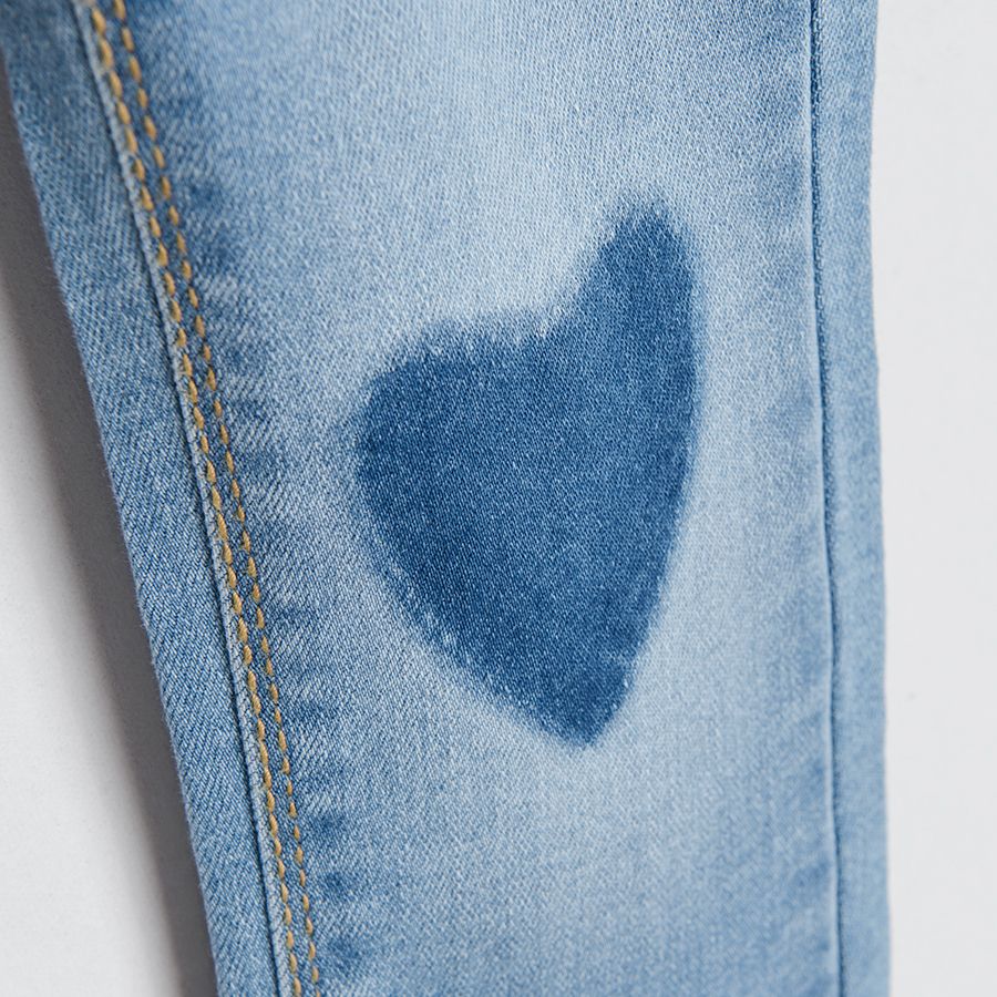 Denim trousers with hearts print on the knees