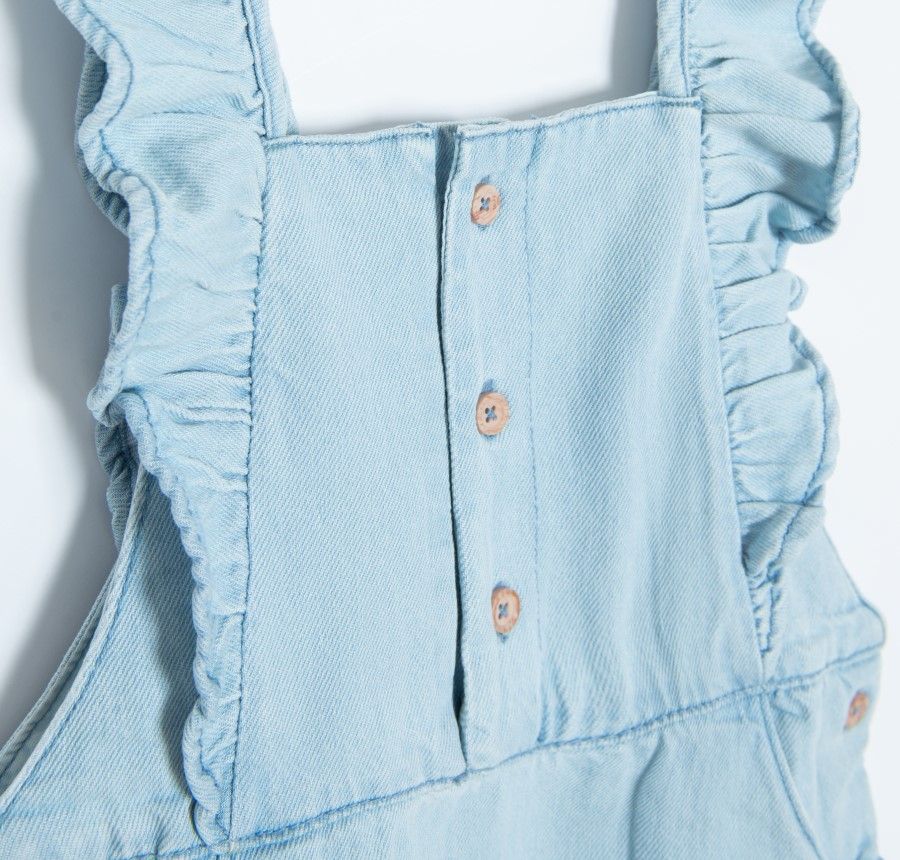 Denim dungaree with skirt buttons and ruffle on the side