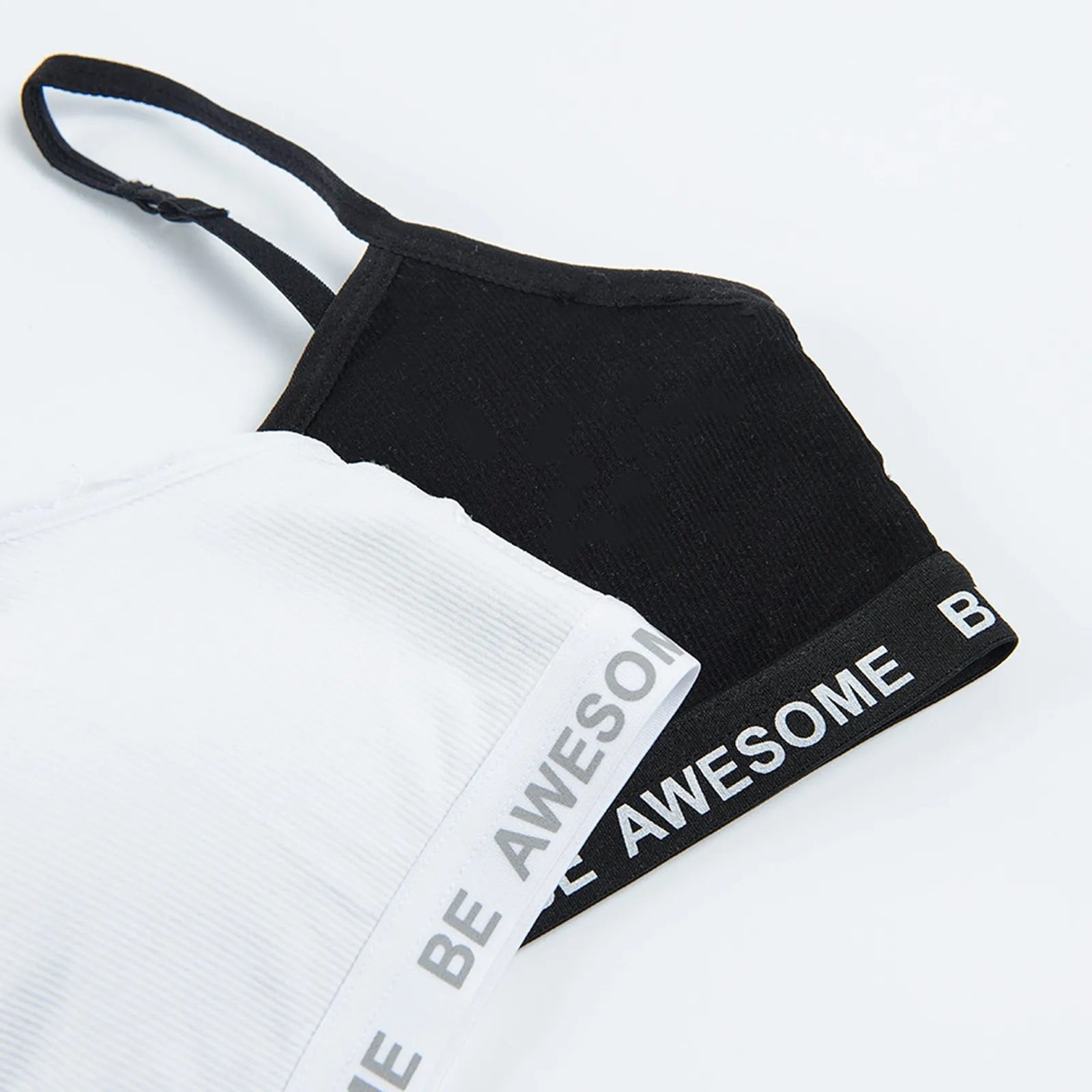 White and black bras with Be awesome print on the elastic band