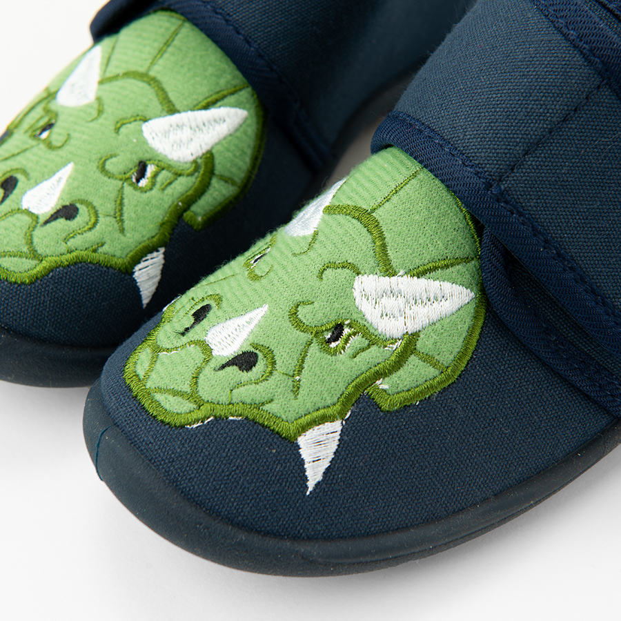 Blue slip on slippers with dinosaur print